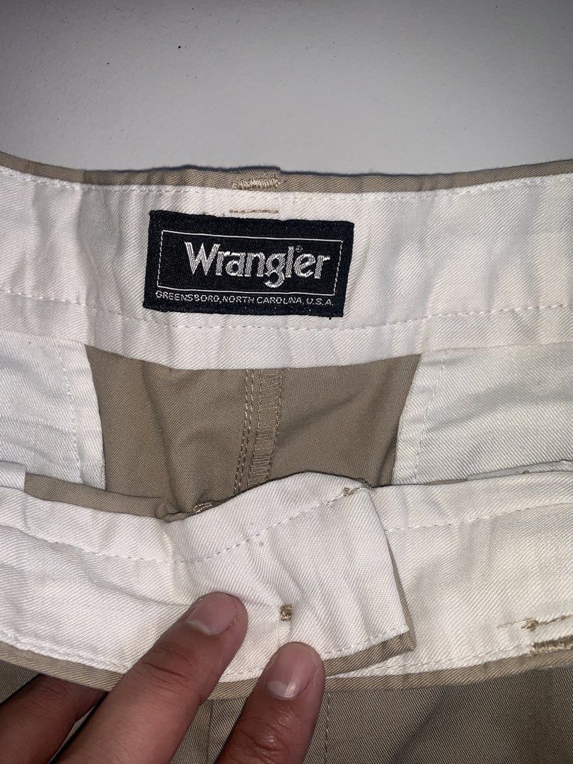 Wrangler Khaki Pleated Trousers (Category: Trousers) located in Mataasnakahoy. Submitted by grailsph.81630 (Listing ID 1465747591, Image 2). Description: - Brand: Wrangler - Style: Pleated trousers / Straight cut - Color: Khaki beige - Origin: Made in Greensboro, NC, U.S.A. - Details: Classic front pleats, belt loops, button closure, clean white inner waistband - 30”-31”W x 39”-40”L - Condition: Great vintage staple piece - Best for: Casual to sm