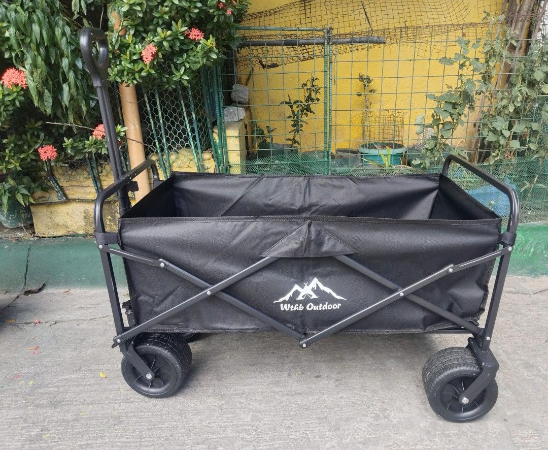 Wthb Outdoor Folding Utility Wagon Black (Category: Hiking & Camping) located in Cavite. Submitted by ambersaints (Listing ID 1465625526, Image 1). Description: - Brand: Wthb Outdoor - Color: Sleek All-Black - Frame: Sturdy metal with heavy-duty fabric - Mobility: Large wheels designed for grass, dirt, and pavement - Handle: Ergonomic loop grip for easy pulling - Storage: Folds completely flat to fit car trunks and tight spaces - Best for: Campin
