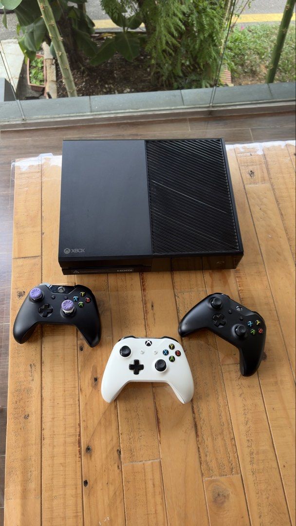Xbox One Console (Category: Xbox) located in Singapore. Submitted by utoppia (Listing ID 1465660321, Image 2). Description: - Platform: Original Xbox One Console (Black) - Condition: Fully tested, 100% working, and ready for gaming - Controllers: 2 controllers included - comes with power cable and hdmi cable -the pairing button on the console might not work.