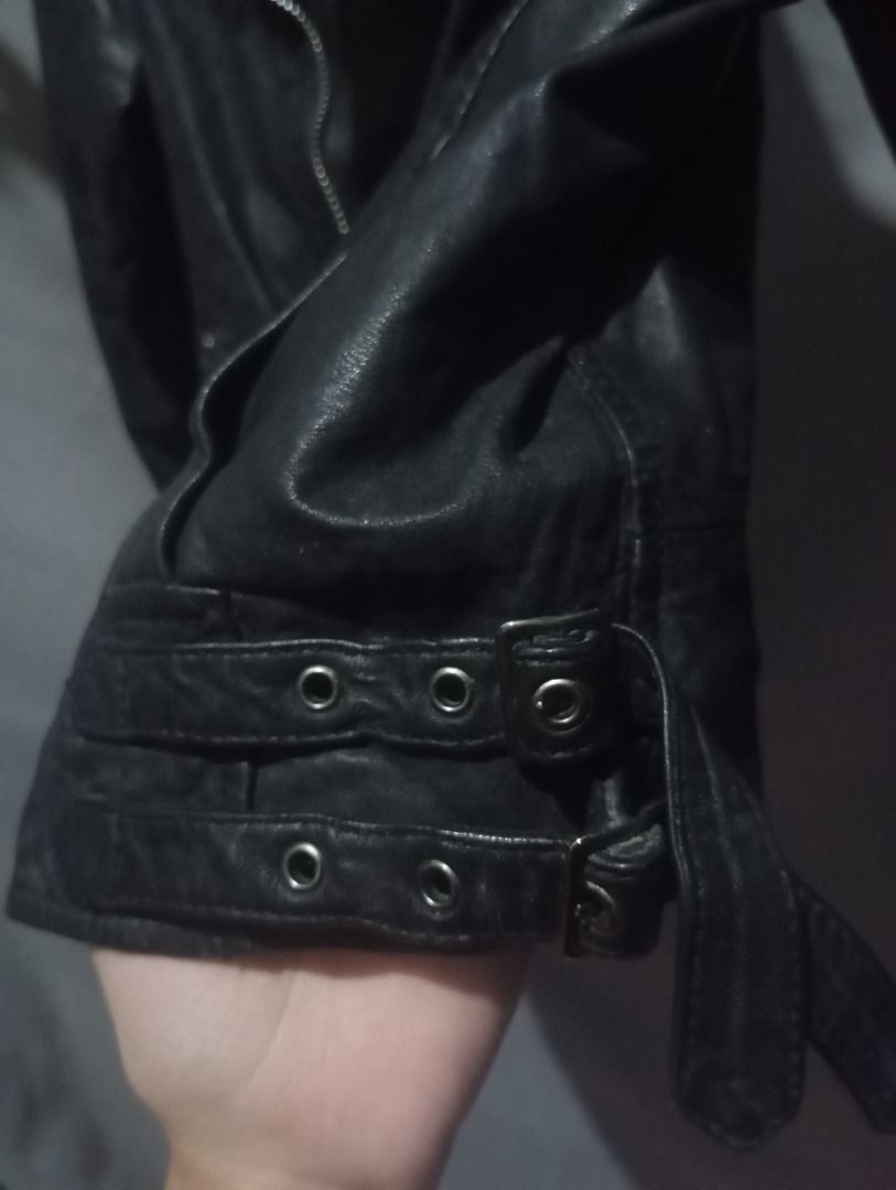 Y2K Black Leather Biker Jacket XS-S (Category: Coats, Jackets and Outerwear) located in Balanga. Submitted by elle.armoire (Listing ID 1465711551, Image 2). Description: - Size: XS (Short cropped fit) - Details: Asymmetric zip front, lapels with metallic studs, and buckle straps on cuffs - Interior: Stylish striped inner lining - Style: Edgy, rock-inspired look .