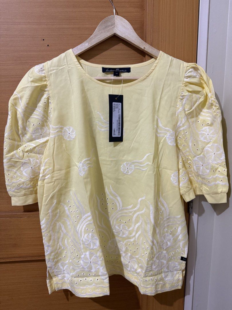 Yellow Embroidered Puff Sleeve Blouse (Category: Blouses) located in Taguig. Submitted by happy.viascloset (Listing ID 1465590336, Image 1). Description: - Brand: Kamiseta (Brand new with tag and original price visible) - Color & Design: Bright yellow with detailed white embroidery on front, hem, and sleeves - Sleeves: Short puff sleeves with gathered shoulders - Neckline: Classic round neckline - Material: Lightweight and comfortable - Styling: 