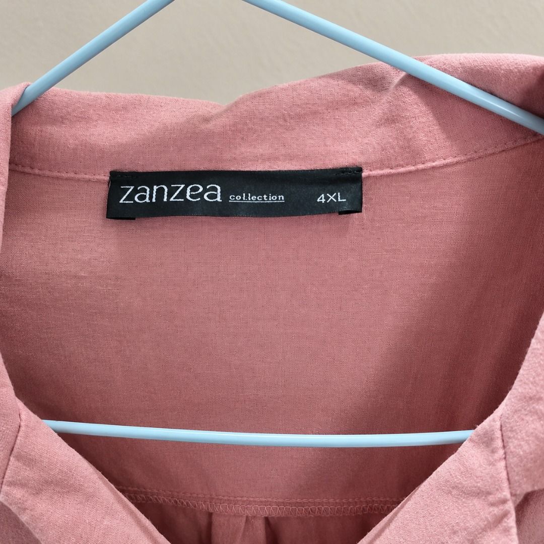 Zanzea Collection Pink Button-Down Short Sleeve Blouse 4XL (Category: Blouses) located in Cavite. Submitted by brightfire.b90615 (Listing ID 1465638185, Image 2). Description: - Brand: Zanzea - Color: Pink with matching buttons - Size: 4XL - Fit: Relaxed and comfortable - Features: Short sleeves, collar neckline, and front button closure - Material: Lightweight fabric, ideal for warm weather and everyday wear.