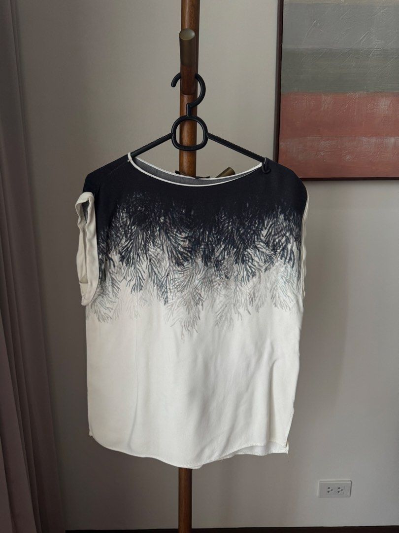 Zara Basic black and white graphic top (Category: Blouses) located in Pasig City. Submitted by kutleyn (Listing ID 1465670454, Image 1). Description: - Brand: Zara Basic - Size: S - Color/Pattern: Black and white with abstract foliage/seaweed fade print - Details: Crew neckline with white trim, cap sleeves with rolled cuffs, lightweight fabric - Made in: Morocco - Condition: Excellent pre-loved condition (easy to style with jeans or skirts) - Shi