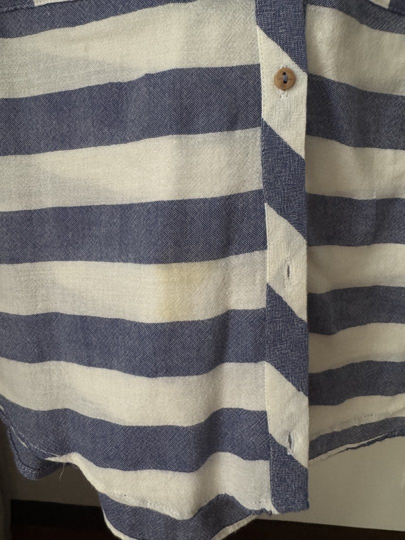 Zara Basic Blue and White Striped Sleeveless Blouse (Category: Sleeveless) located in Pasig City. Submitted by kutleyn (Listing ID 1465672494, Image 3). Description: - Brand: Zara Basic - Style: Blue and white striped sleeveless blouse with V-neck, front button closure, and two chest pockets - Size: XS - Material: Lightweight fabric, ideal for warm weather - Condition: Good, but with a small yellow stain near the bottom front hem.