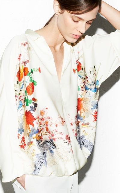 Zara Basic Floral Wrap Blouse White M (Category: Blouses) located in Makati City. Submitted by 1st_Dibs (Listing ID 1465628449, Image 2). Description: - Brand: Zara Basic - Size: M (Made in Morocco) - Color: Off-white - Design: V-neck wrap style with collar, long sleeves, and gathered draped hem - Details: Intricate embroidered floral and koi fish motifs on front panels - Styling: Pairs wonderfully with white denim or trousers for a chic, versati