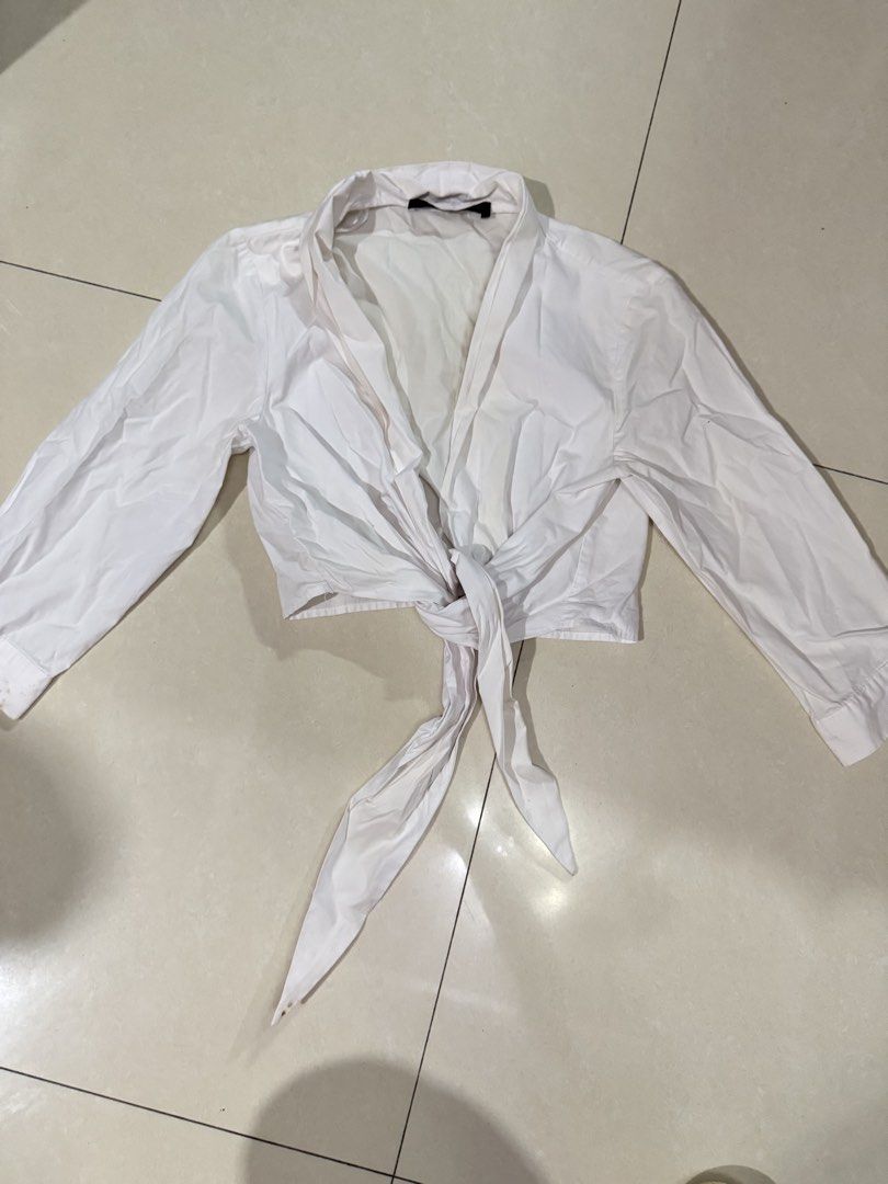 Zara Basic White Crop Tie Blouse XS (Category: Blouses) located in Quezon City. Submitted by sweetlyluxe (Listing ID 1465624642, Image 1). Description: - Brand/Model: Zara Basic - Size: XS (Made in Turkey) - Color/Fabric: Clean solid white - Details: Long sleeves with cuffs, collar neckline, front tie detail - Condition: yellowish on some parts, use zonrox or bleach - Styling: Perfect to pair with high-waisted jeans or skirts.