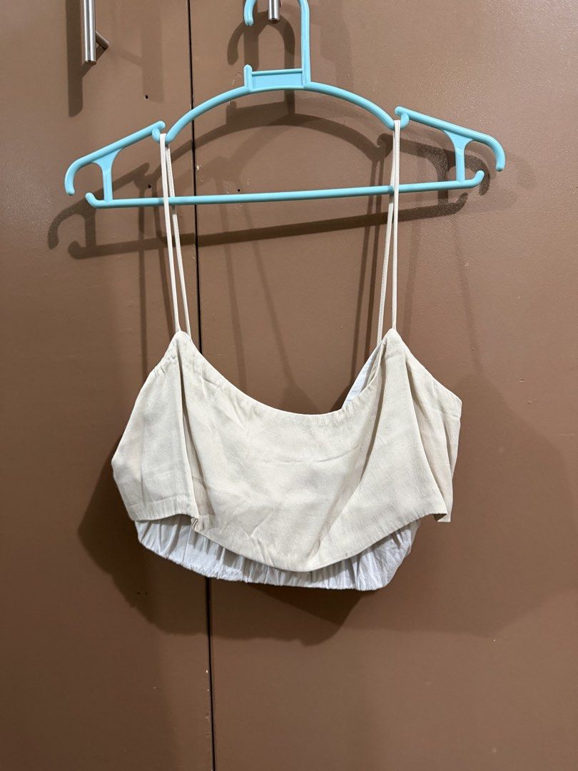 Zara Beige Spaghetti Strap Crop Top Size XS (Category: Sleeveless) located in Quezon City. Submitted by declutterbycy (Listing ID 1465758847, Image 1). Description: - Brand: Zara - Size: XS (Made in Turkey) - Color: Beige with a layered white hem - Details: Thin spaghetti straps, lightweight fabric - Condition: Clean and well-maintained - Styling: Perfect to match with high-waisted shorts or skirts.