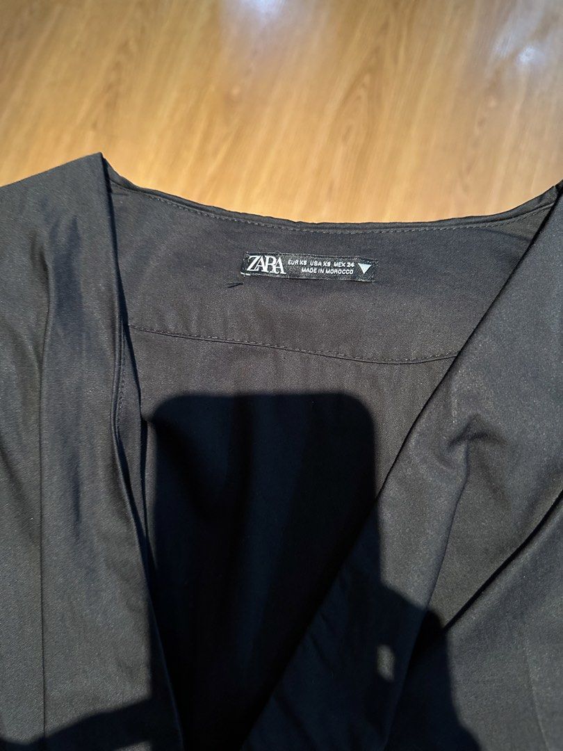 Zara Black V-neck Dress (Category: Dresses) located in Mandaluyong City. Submitted by unworntobarelyworn (Listing ID 1461337651, Image 1). Description: Condition: 9/10 - Elegant black V-neck dress (worn only once) - Flattering cinched waist with elastic back for comfort - Beautiful pleated skirt detail - Short, fluttery sleeves for a stylish touch - Perfect for various occasions, easy to wear - Can fit XS to S.