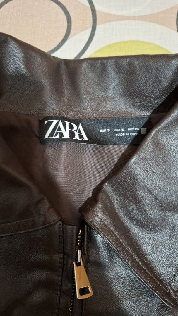 Zara Brown Faux Leather Jacket Size S (Category: Coats, Jackets and Outerwear) located in Paranaque City. Submitted by furotetsuu (Listing ID 1465671488, Image 3). Description: - Brand: Zara - Size: S - Material: Faux Leather - Color: Brown - Design: Classic collared with front zipper closure - Pockets: Two front pockets - Condition: Great outerwear piece for cooler days, needs ironing - Not sure if legit but great quality - Used once for Korea t