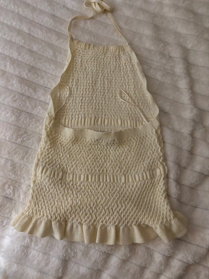 ZARA Cream Knit Halter Top Backless Ruffle Hem (Category: Sleeveless) located in Quezon City. Submitted by hadescloset (Listing ID 1465654655, Image 2). Description: - Used once - Bought for ₱1,999 - Cream knit halter top with all-over textured smocking - Open back design with adjustable tie neck straps - Cute ruffled hem for extra movement - Stretchy and snug-fitting fabric - Ideal for summer days or night outs.
