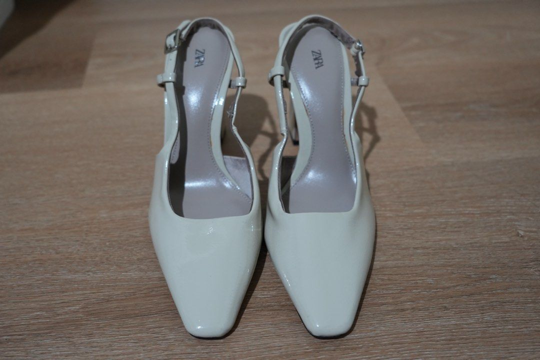 Zara Cream Slingback Heels Size 37 (Category: Heels) located in Cainta. Submitted by karsssss (Listing ID 1465756927, Image 1). Description: - Brand: Zara - Style: Patent slingback heels with square toe and block heel - Color: Cream - Size: 37 - Closure: Adjustable ankle strap with buckle .