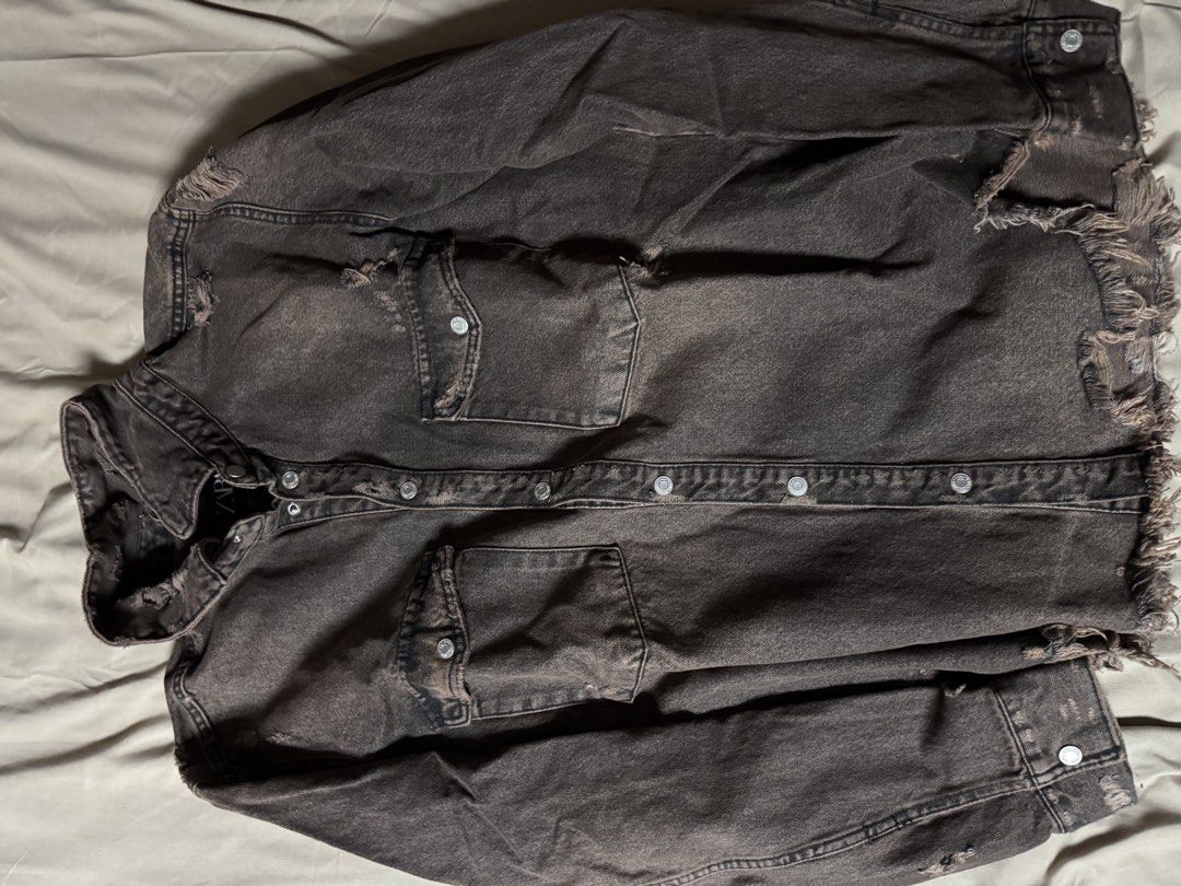 Zara distressed brown denim jacket oversized XL (Category: Coats, Jackets and Outerwear) located in Manila. Submitted by seangoart (Listing ID 1465585111, Image 1). Description: - Brand: Zara - Size: XL - Color: Washed brown with a heavy faded, vintage aesthetic - Details: Heavy distressing and frayed raw edges at the hem and collar - Pockets: Double chest pockets with snap button closures - Closure: Front button closure and buttoned cuffs.