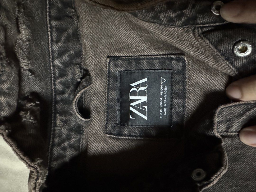 Zara distressed brown denim jacket oversized XL (Category: Coats, Jackets and Outerwear) located in Manila. Submitted by seangoart (Listing ID 1465585111, Image 2). Description: - Brand: Zara - Size: XL - Color: Washed brown with a heavy faded, vintage aesthetic - Details: Heavy distressing and frayed raw edges at the hem and collar - Pockets: Double chest pockets with snap button closures - Closure: Front button closure and buttoned cuffs.