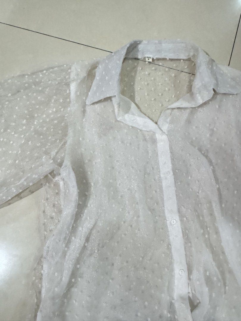 Zara inspired White Sheer Polka Dot Button-Up Blouse (Category: Blouses) located in Quezon City. Submitted by sweetlyluxe (Listing ID 1465624462, Image 2). Description: - Color: White - Size: S - Fabric: Lightweight with all-over dot texture - Design: Classic collar, long sleeves, button-down front - Styling: Perfect for layering over bralettes or camisoles.