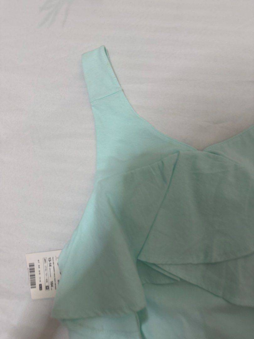 Zara Mint Green Ruffle Top Size 13-14 (Category: Sleeveless) located in Santa Rosa. Submitted by decluttering_. (Listing ID 1465623982, Image 2). Description: - Brand: Zara - Size: 13-14 years / 164 cm - Color: Mint green (pastel) - Condition: Brand new with original tags attached (never worn) - Material: Soft, breathable cotton - Features: Statement front ruffles, sleeveless with wide straps.