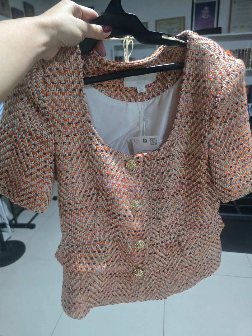 Zara Textured Tweed Crop Jacket Orange (Category: Coats, Jackets and Outerwear) located in Manila. Submitted by rcloset___ (Listing ID 1465632467, Image 3). Description: - Brand: Zara - Style: Textured tweed crop jacket with short sleeves and scoop neckline - Color: Vibrant orange with multicolor woven threads (hints of pink and purple) - Details: Gold-toned embossed front buttons, two front flap pockets, fully lined in white fabric - Condition: 