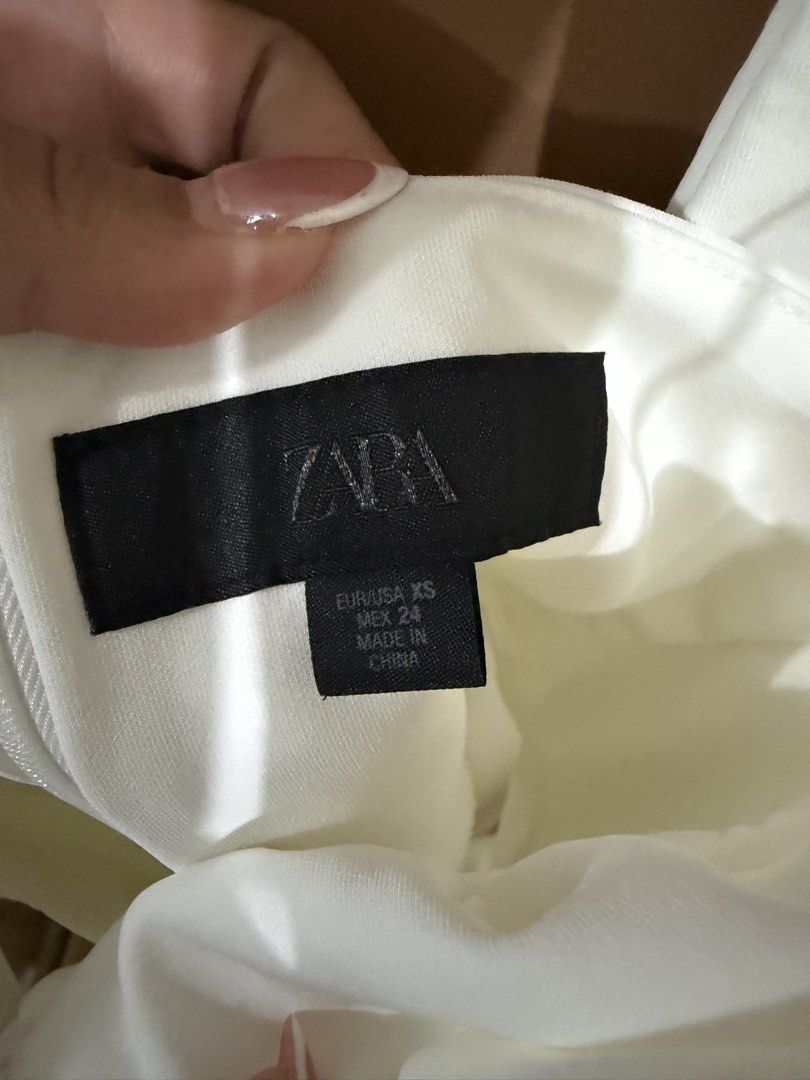 Zara White Halter Neck Mini Dress (Category: Dresses) located in Quezon City. Submitted by declutterbycy (Listing ID 1465758729, Image 2). Description: - Brand: Zara - Size: XS - Color: Clean solid white - Style: Deep V-neck, halter straps, structured bodice, and flared skater skirt - Material: Lightweight and easy to style - Condition: Worn just a couple of times, still in great shape - Perfect for: Parties and night outs.