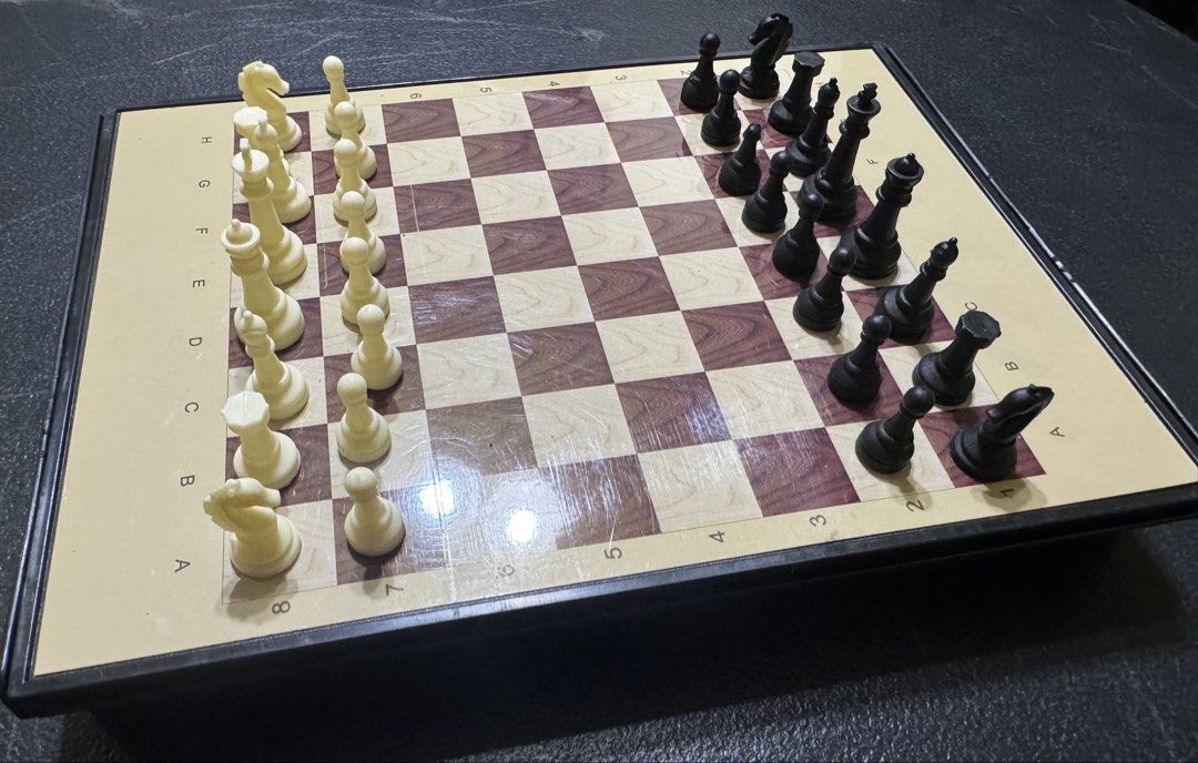 2-in-1 Chess and Snakes & Ladders Board Game Set (Category: Board Games & Puzzles) located in San Pedro. Submitted by pageturner19 (Listing ID 1471141689, Image 2). Description: - 2-in-1 reversible board game: Standard chess on one side, classic snakes and ladders on the other - Complete set includes black and white chess pieces, colorful pawns, and dice - Built-in storage compartment inside the foldable board to keep all pieces secure - Travel-f