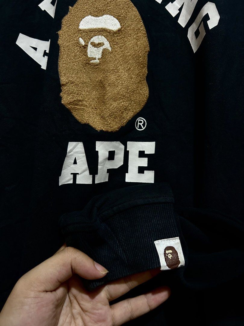 A Bathing Ape BAPE Arch Logo Black Sweatshirt (Category: Coats, Jackets and Outerwear) located in Calbayog City. Submitted by thrift.bucks101 (Listing ID 1471236713, Image 3). Description: - Brand: A Bathing Ape (BAPE) by Nowhere Co., Ltd. - Color: Black - Size: XXL - Material: 100% premium cotton - Design: Large chenille ape head graphic with printed arch lettering - Details: Classic ape head sleeve tag on left cuff - Condition: Clean, worn a fe