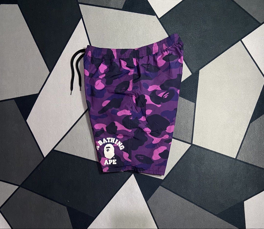 A Bathing Ape BAPE Reversible Shark Camo Shorts (Category: Shorts) located in Manila. Submitted by trueeagle-0a08 (Listing ID 1471189855, Image 3). Description: Bàpé purple camo reversible short ! 30 - 34 waist x 19 length Size medium | 10 color rate flawless | need wash only Authentic | OG - Brand: BAPE - Style: Reversible shorts - Design A: Purple camo - Design B: Black shark face graphic - Details: Adjustable drawstring waistband with branded 