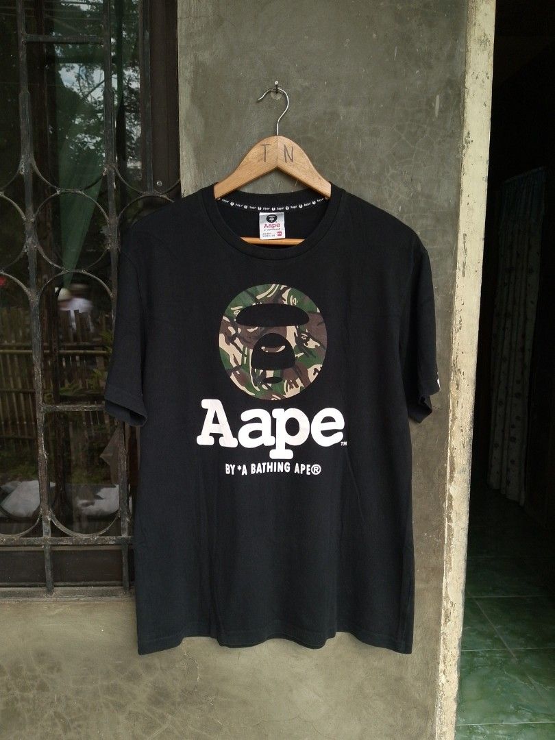 Aape By A Bathing Ape Black Camo Tee (Category: Tshirts & Polo Shirts ) located in Kabankalan. Submitted by evolasdf (Listing ID 1471157185, Image 1). Description: AAPE BY A BATHING APE® Camo Moonface Size: XXL on tag best fit medium to large Dimes: 20x28 - Excellent Condition - Issue cut washtag / Color Rate 9.5/10 📩 LOCATION 📍: Brgy Oringao Kabankalan City.