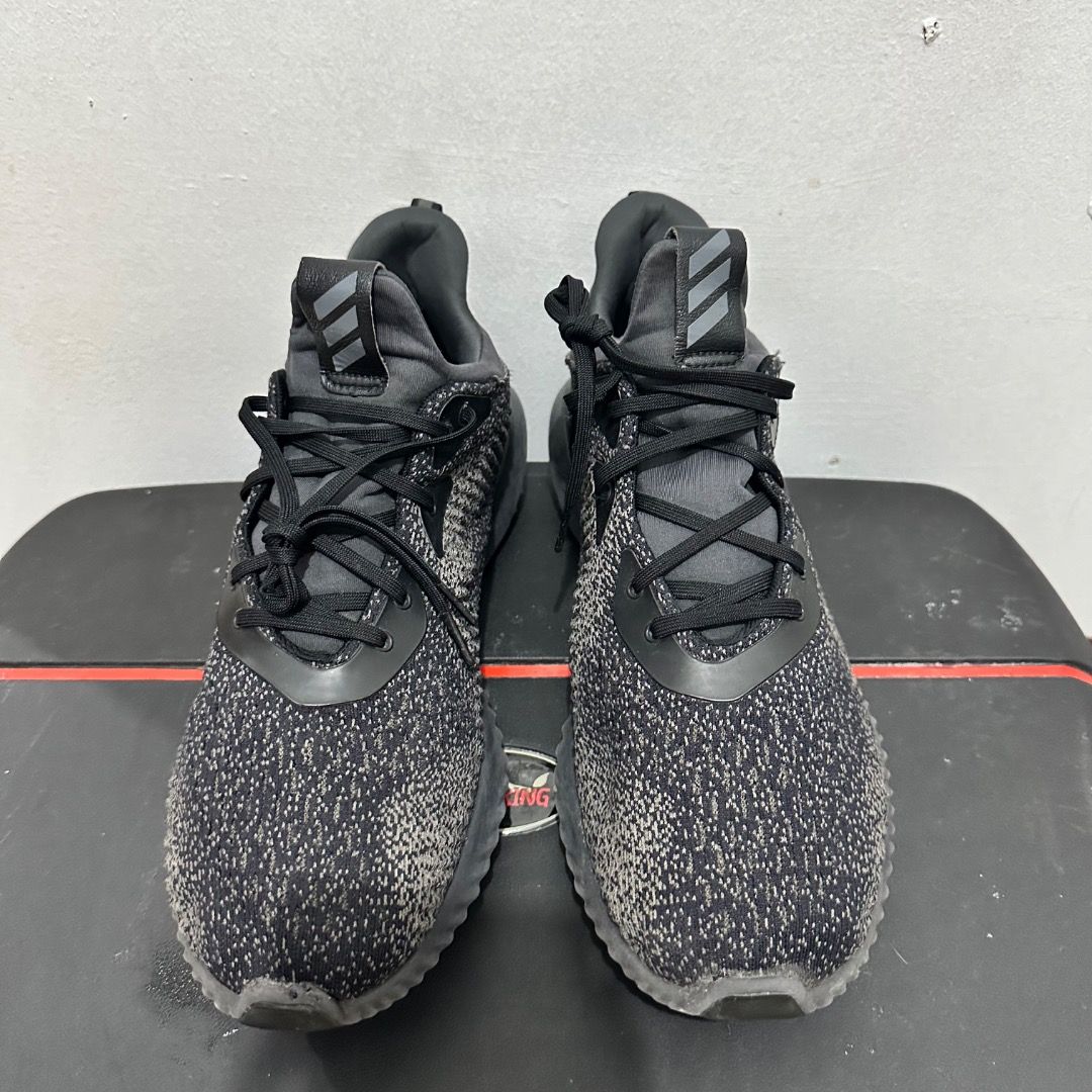 Adidas Alphabounce Black Grey Running Shoes (Category: Sneakers) located in Manila. Submitted by johnpm (Listing ID 1471239828, Image 3). Description: - Brand/Model: Adidas Alphabounce - Color: Black and Dark Grey - Material: Comfortable knit upper with ribbed EVA midsole - Features: Lace-up closure with pull tabs at the tongue and heel - Condition: Minimal signs of wear on soles and uppers, solid grip and supportive cushioning - Best For: Daily 
