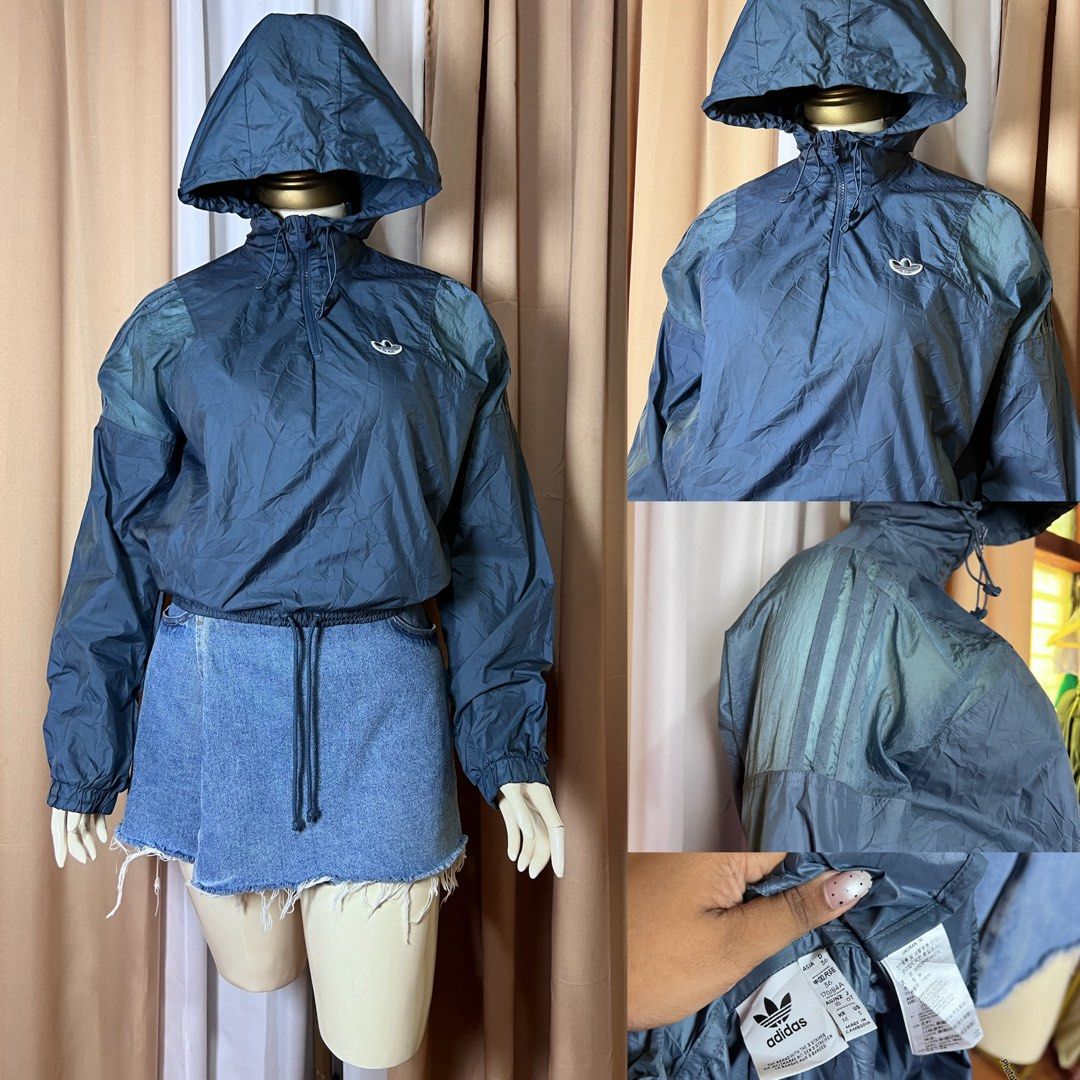 Adidas Blue Hooded Windbreaker Jacket (Category: Coats, Jackets and Outerwear) located in Kidapawan. Submitted by frizzyjayne (Listing ID 1471247441, Image 1). Description: Dark blue Adidas windbreaker with a hood. Half-zip front, adjustable drawstrings at the neck and hem. Sheer panel details on the shoulders and sleeves with the classic three stripes. Elastic cuffs. Inside tag shows size details and branding. Lightweight material, easy to throw