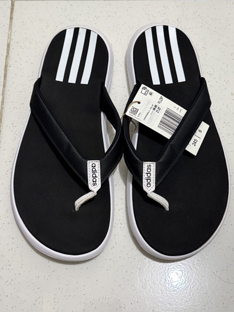 Adidas Comfort Flip-Flops Black White Size 7 (Category: Slippers and slides) located in Binan City. Submitted by just4stuffs (Listing ID 1471257609, Image 1). Description: - Brand: Adidas - Style: Thong flip-flops with classic three-stripe design - Color: Black and white with white strap branding - Size: 7 US - Condition: Brand new with tag.