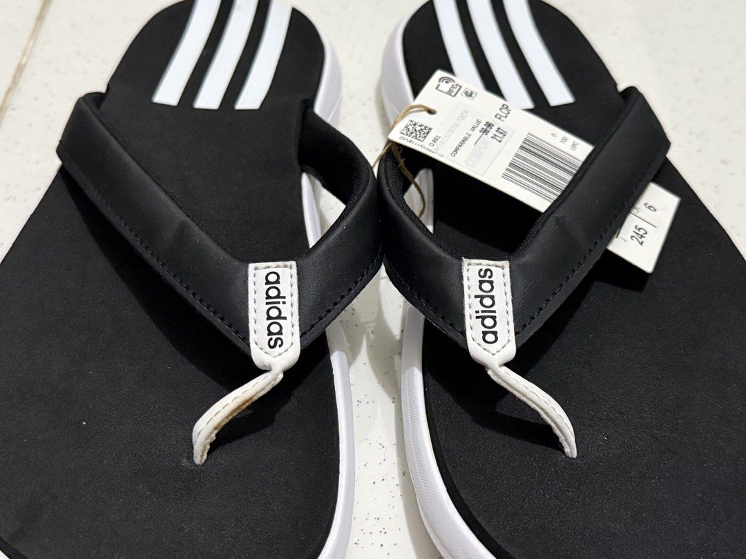 Adidas Comfort Flip-Flops Black White Size 7 (Category: Slippers and slides) located in Binan City. Submitted by just4stuffs (Listing ID 1471257609, Image 2). Description: - Brand: Adidas - Style: Thong flip-flops with classic three-stripe design - Color: Black and white with white strap branding - Size: 7 US - Condition: Brand new with tag.