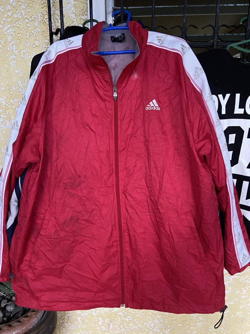Adidas Red Windbreaker Jacket with White Stripes Size L (Category: Coats, Jackets and Outerwear) located in Manila. Submitted by koolash (Listing ID 1471136262, Image 1). Description: - Brand: Adidas - Item: Red windbreaker jacket with iconic white striped sleeves - Features: Full zip closure, stand collar, breathable mesh lining, and adjustable hem drawcords - Size: UK 44/46, USA L (check measurements for best fit) - Origin: Made in China - Cond