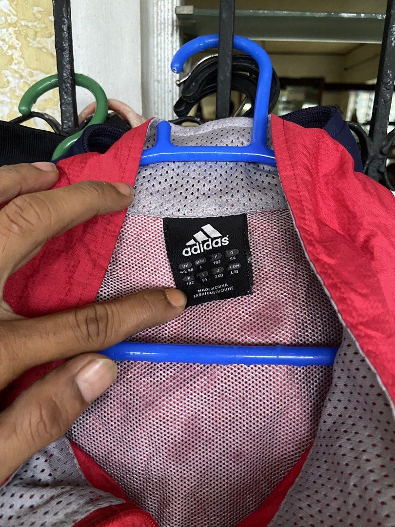Adidas Red Windbreaker Jacket with White Stripes Size L (Category: Coats, Jackets and Outerwear) located in Manila. Submitted by koolash (Listing ID 1471136262, Image 2). Description: - Brand: Adidas - Item: Red windbreaker jacket with iconic white striped sleeves - Features: Full zip closure, stand collar, breathable mesh lining, and adjustable hem drawcords - Size: UK 44/46, USA L (check measurements for best fit) - Origin: Made in China - Cond