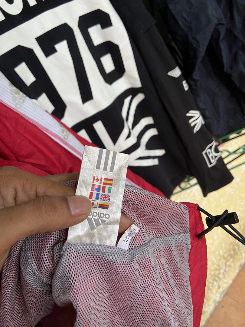 Adidas Red Windbreaker Jacket with White Stripes Size L (Category: Coats, Jackets and Outerwear) located in Manila. Submitted by koolash (Listing ID 1471136262, Image 3). Description: - Brand: Adidas - Item: Red windbreaker jacket with iconic white striped sleeves - Features: Full zip closure, stand collar, breathable mesh lining, and adjustable hem drawcords - Size: UK 44/46, USA L (check measurements for best fit) - Origin: Made in China - Cond