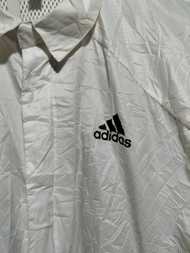 Adidas White wind.rdy Windbreaker Jacket (Category: Coats, Jackets and Outerwear) located in Valencia. Submitted by cabisaythriftshop (Listing ID 1471224825, Image 3). Description: - Brand: Adidas - Style: Windbreaker Jacket - Color: White with black logo - Tech: Wind.Rdy (wind-resistant) - Size: Large - Features: Classic collar, front zip with snap buttons, side pockets, and breathable mesh inner lining - Condition: Excellent - Perfect for: Outd