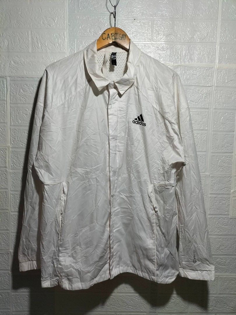 Adidas White wind.rdy Windbreaker Jacket (Category: Coats, Jackets and Outerwear) located in Valencia. Submitted by cabisaythriftshop (Listing ID 1471224825, Image 1). Description: - Brand: Adidas - Style: Windbreaker Jacket - Color: White with black logo - Tech: Wind.Rdy (wind-resistant) - Size: Large - Features: Classic collar, front zip with snap buttons, side pockets, and breathable mesh inner lining - Condition: Excellent - Perfect for: Outd