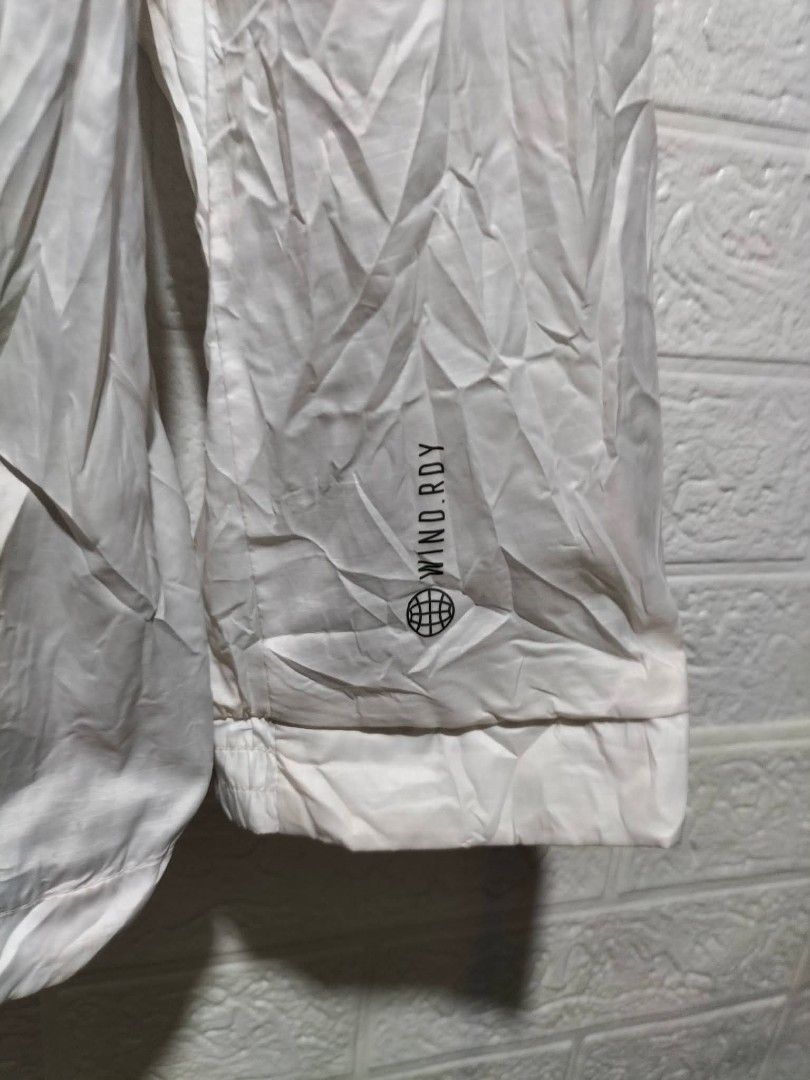 Adidas White wind.rdy Windbreaker Jacket (Category: Coats, Jackets and Outerwear) located in Valencia. Submitted by cabisaythriftshop (Listing ID 1471224825, Image 2). Description: - Brand: Adidas - Style: Windbreaker Jacket - Color: White with black logo - Tech: Wind.Rdy (wind-resistant) - Size: Large - Features: Classic collar, front zip with snap buttons, side pockets, and breathable mesh inner lining - Condition: Excellent - Perfect for: Outd