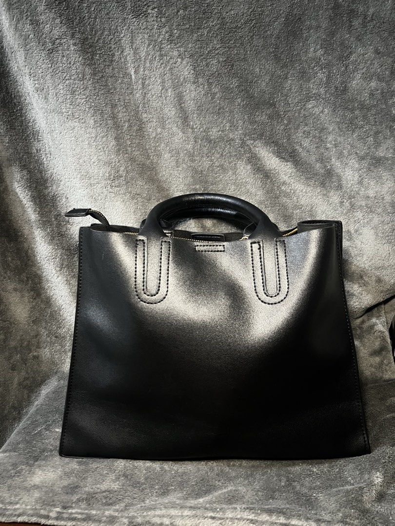 AFANDI Black Leather Tote Handbag (Category: Tote Bags) located in Manila. Submitted by serenathriftstore (Listing ID 1471181800, Image 2). Description: - Brand: AFANDI - Color: Classic Black - Material: Smooth faux leather with solid hardware - Closure: Secure zip top - Design: Clean minimalist look with subtle brand lettering and stitched U-shaped accents on front and back - Carry: Twin top handles and sturdy base - Capacity: Spacious interior,