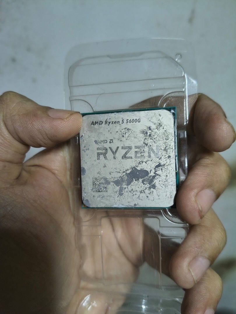 AMD Ryzen 5 5600G Processor (Category: Computer Parts) located in Quezon City. Submitted by jimpierrereyes (Listing ID 1471174762, Image 1). Description: - Item: AMD Ryzen 5 5600G Desktop Processor - Packaging: Stored inside a clear plastic clamshell container - Condition: Heatspreader has leftover thermal paste residue; text and logos remain clearly legible - Note: Pins not pictured, sold strictly as seen in photos - Best For: Great upgrade or b