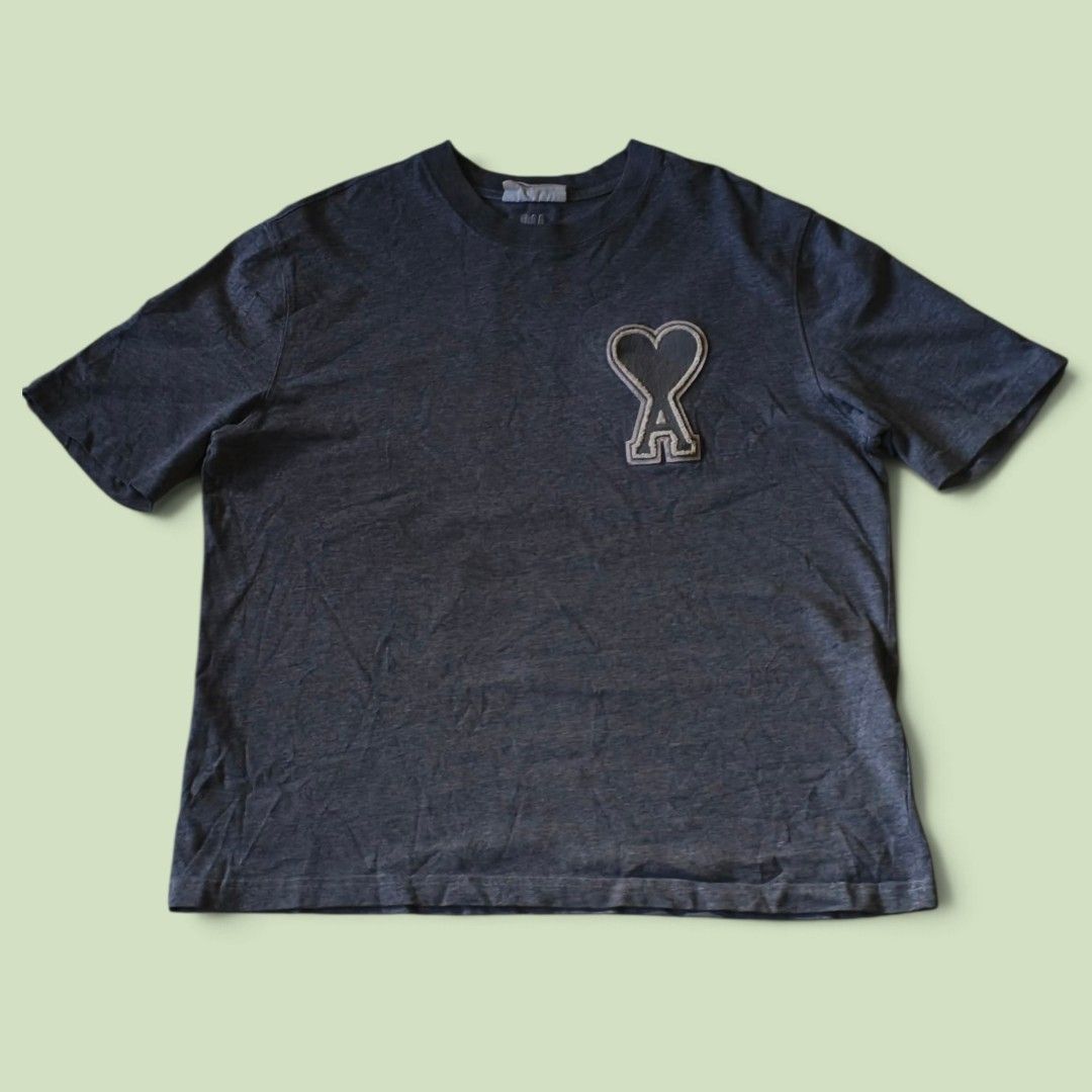 Ami Paris Heart Patch T-Shirt Dark Grey (Category: Tshirts & Polo Shirts ) located in Indang. Submitted by shanlennon09 (Listing ID 1471131550, Image 1). Description: - L-XL -Brand: Ami Paris - Color: Dark grey - Design: Short sleeves, crew neck, iconic felt heart logo patch on left chest - Fit: Relaxed fit - Material: Soft, comfortable cotton - Condition: Brand new / Excellent (ready to ship).