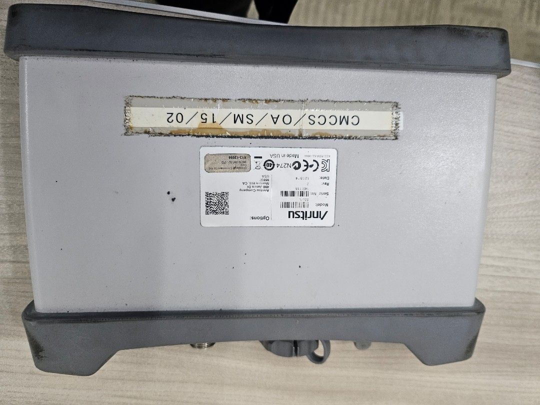 Anritsu S331L SiteMaster Cable and Antenna Analyzer (Category: Industrial Equipment) located in Pasig City. Submitted by ramleb123 (Listing ID 1471197887, Image 3). Description: - Model: Anritsu S331L SiteMaster Cable and Antenna Analyzer - Frequency Range: Up to 4 GHz - Build: Rugged grey and black housing with protective rubber bumpers and top handle strap - Condition: Shows normal dust and wear from field use - Identification: Calibration stic