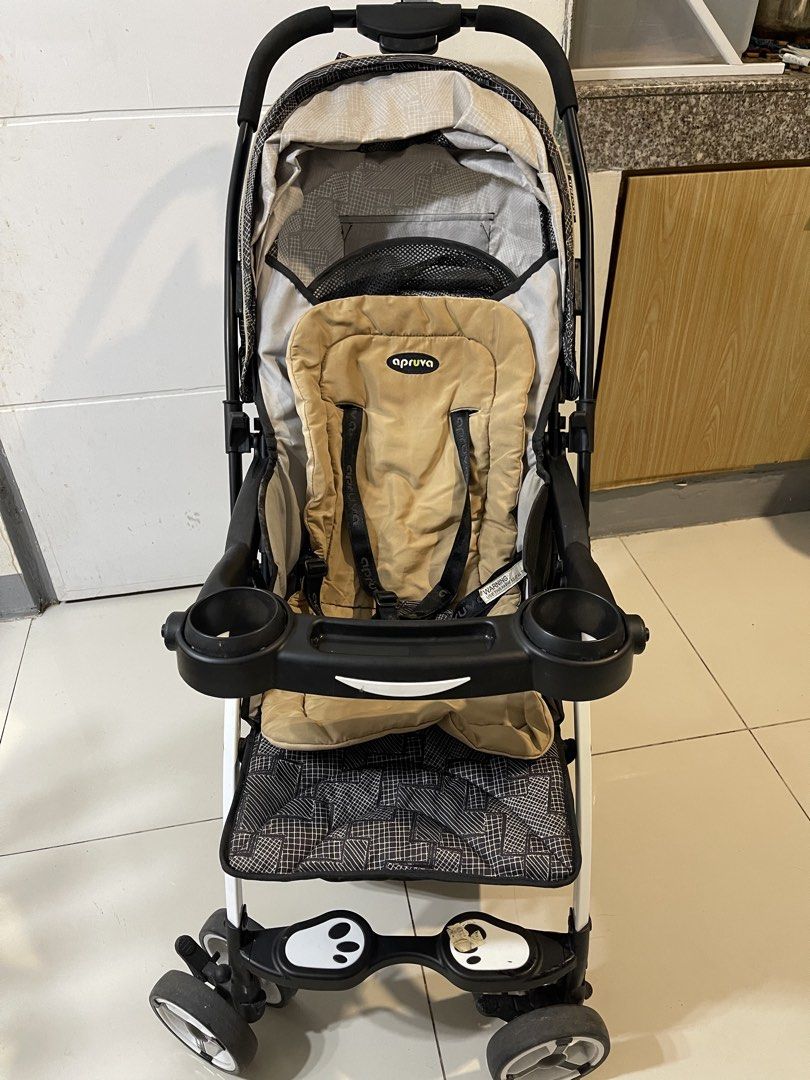 Apruva Aller Baby Stroller Black Beige (Category: Strollers) located in Quezon City. Submitted by fastdolphin_85dfc3 (Listing ID 1471287069, Image 1). Description: - Brand/Model: Apruva Aller Baby Stroller - Color/Design: Black geometric pattern with a cozy beige seat insert - Safety: 5-point harness system and secure foot brakes - Comfort: Multi-position recline and padded push handle - Convenience: Snack tray with dual cup holders, full coverag