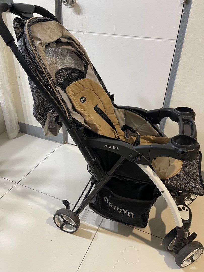Apruva Aller Baby Stroller Black Beige (Category: Strollers) located in Quezon City. Submitted by fastdolphin_85dfc3 (Listing ID 1471287069, Image 2). Description: - Brand/Model: Apruva Aller Baby Stroller - Color/Design: Black geometric pattern with a cozy beige seat insert - Safety: 5-point harness system and secure foot brakes - Comfort: Multi-position recline and padded push handle - Convenience: Snack tray with dual cup holders, full coverag