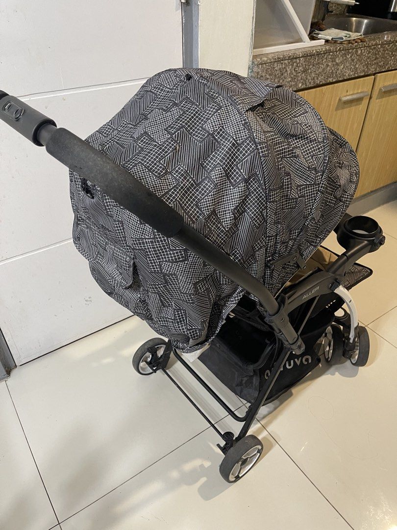 Apruva Aller Baby Stroller Black Beige (Category: Strollers) located in Quezon City. Submitted by fastdolphin_85dfc3 (Listing ID 1471287069, Image 3). Description: - Brand/Model: Apruva Aller Baby Stroller - Color/Design: Black geometric pattern with a cozy beige seat insert - Safety: 5-point harness system and secure foot brakes - Comfort: Multi-position recline and padded push handle - Convenience: Snack tray with dual cup holders, full coverag