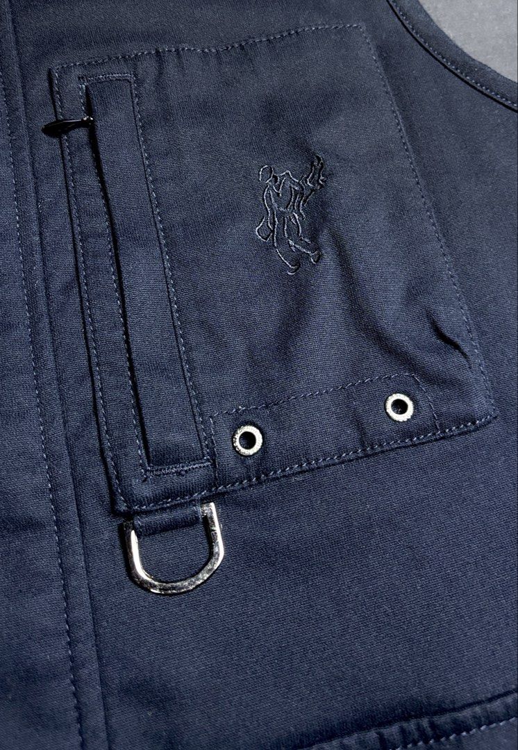 Ashworth Full-Zip With Buttons Vest (Category: Vests) located in Bacoor. Submitted by calvinmanzano13 (Listing ID 1471221806, Image 2). Description: - L = 25.5” | W = 21” - Color: Navy Blue - Warm quilted inner lining - Multiple front flap pockets with metal snap buttons - Extra chest zipper compartment and D-ring detail - Full zip closure with snap button placket - Stand-up collar - Clean fabric and hardware, great for layering Notes: 🔥 Hand wa