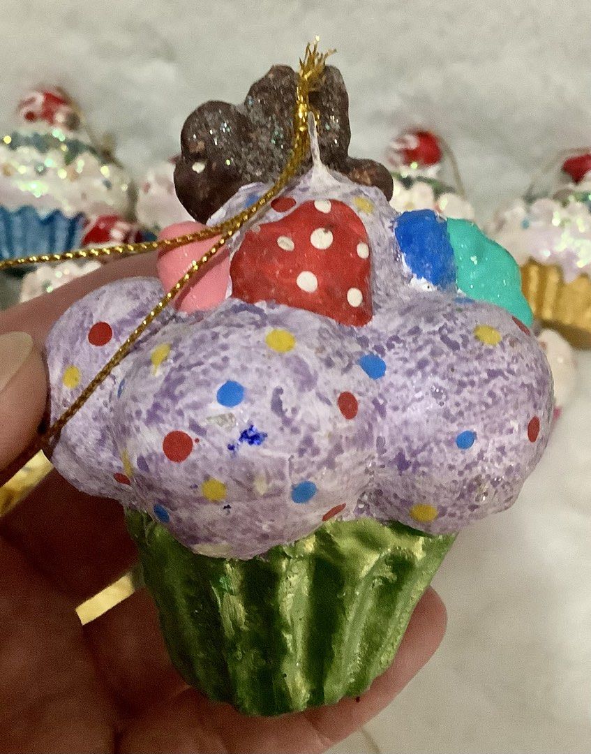 Assorted Cupcake Christmas Tree Ornaments Glitter Holiday Decor (Category: Other Home Decor) located in Quezon City. Submitted by heybailey (Listing ID 1471146242, Image 2). Description: - Handmade cupcake Christmas tree ornaments - Features lots of glitter, vibrant sprinkles, and realistic frosting details - Available in gold, pink, blue, yellow, and green cupcake liners - Topped with cute cherries or candies - Equipped with gold hanging strings