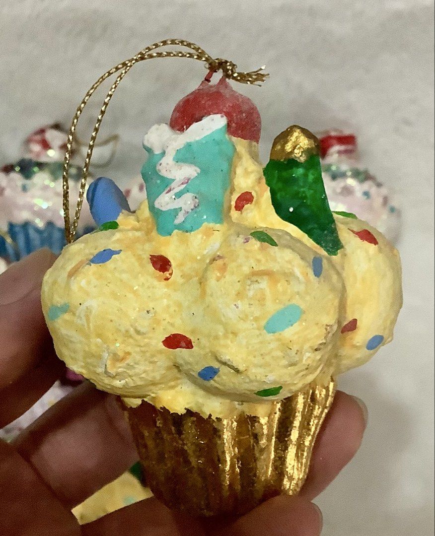 Assorted Cupcake Christmas Tree Ornaments Glitter Holiday Decor (Category: Other Home Decor) located in Quezon City. Submitted by heybailey (Listing ID 1471146242, Image 3). Description: - Handmade cupcake Christmas tree ornaments - Features lots of glitter, vibrant sprinkles, and realistic frosting details - Available in gold, pink, blue, yellow, and green cupcake liners - Topped with cute cherries or candies - Equipped with gold hanging strings