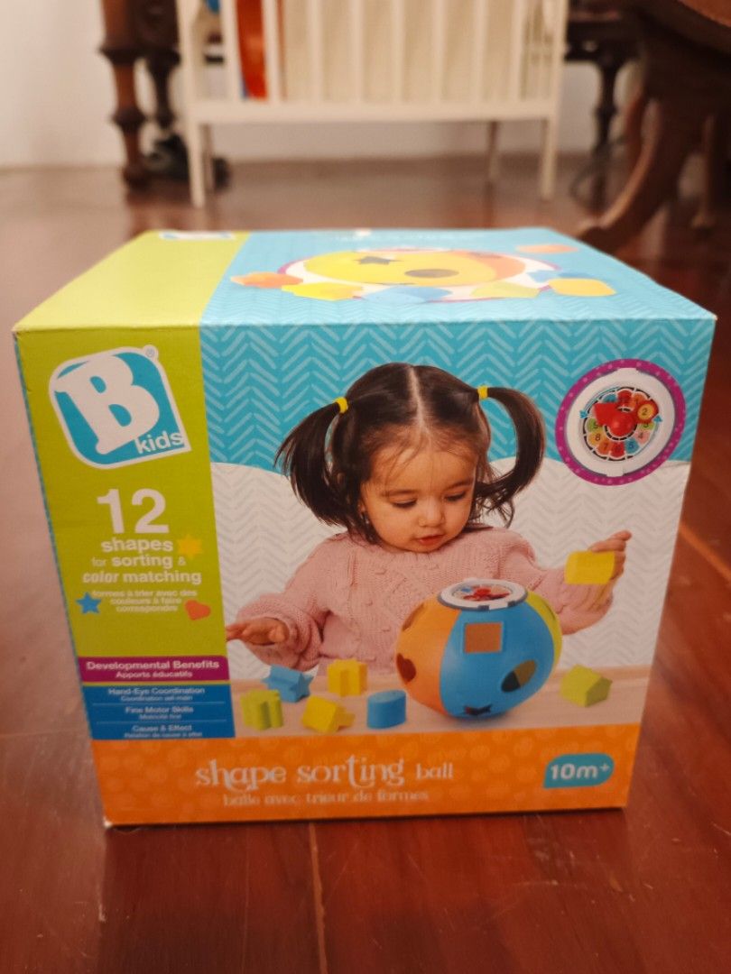 B. kids Shape Sorting Ball 12 Shapes 10m+ (Category: Educational & Learning Toys) located in Makati City. Submitted by ayekai (Listing ID 1471215500, Image 1). Description: - Brand: B. Kids Shape Sorting Ball - Recommended Age: 10 months and up - Features: 12 different shapes for sorting and color matching Bran - Benefits: Helps build hand-eye coordination and fine motor skills - Design: Colorful pieces with multi-textured surfaces - Condition: B