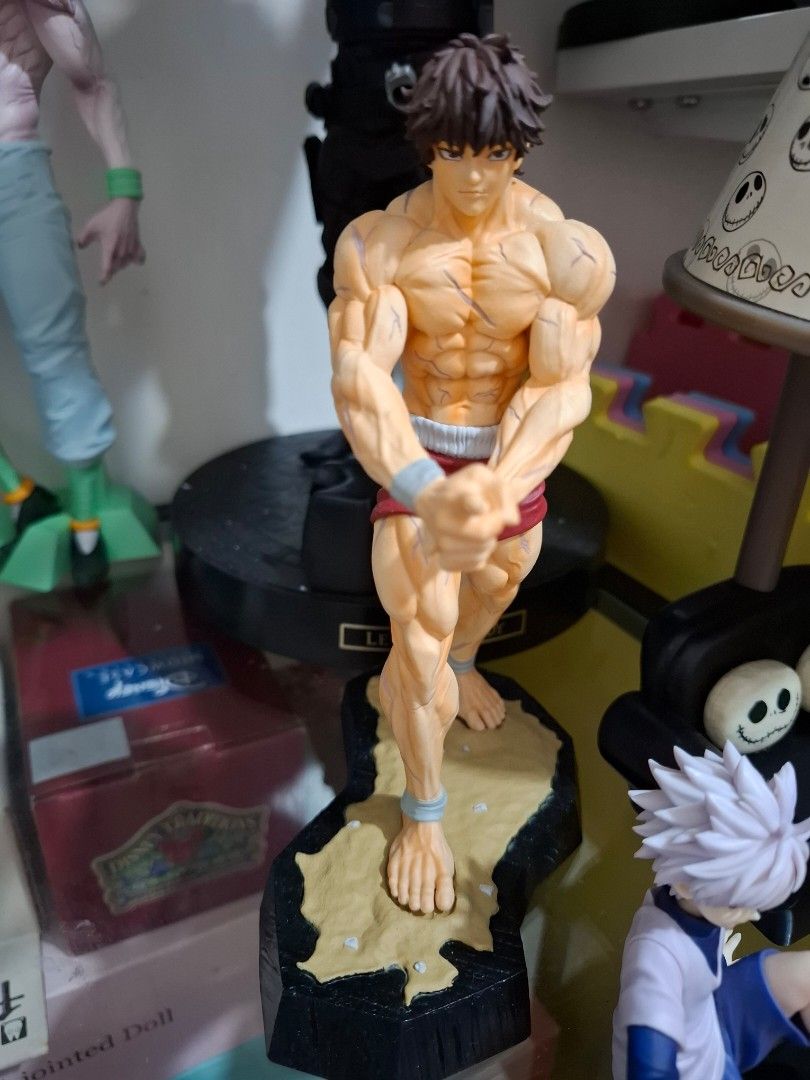 Baki Hanma Anime Action Figure (Category: Figurines & Statues) located in Orion. Submitted by timburtonfan (Listing ID 1471125598, Image 1). Description: - Character: Baki Hanma - Pose: Classic fighting stance with wrapped hands and wrists - Details: Highly detailed muscular physique and realistic torso battle scars - Hair/Expression: Brown hair with a focused, determined expression - Base: Includes a sturdy black display base - Condition: Brand 