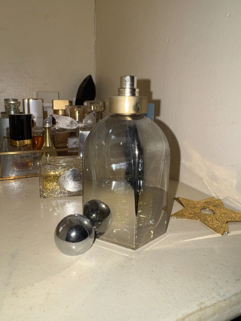Balenciaga Paris Eau de Parfum 75ml (Category: Fragrance & Deodorants) located in Cebu City. Submitted by _t.rix (Listing ID 1471139905, Image 3). Description: - Authentic Balenciaga Paris perfume bottle - Size: 75ml / 2.5 fl oz (marked on bottom base) - Volume: Roughly half full - Design: Hexagonal glass with metallic silver collar, round ball cap, and spray nozzle - Condition: Visible scratches on both the glass and metallic parts - Ideal for d