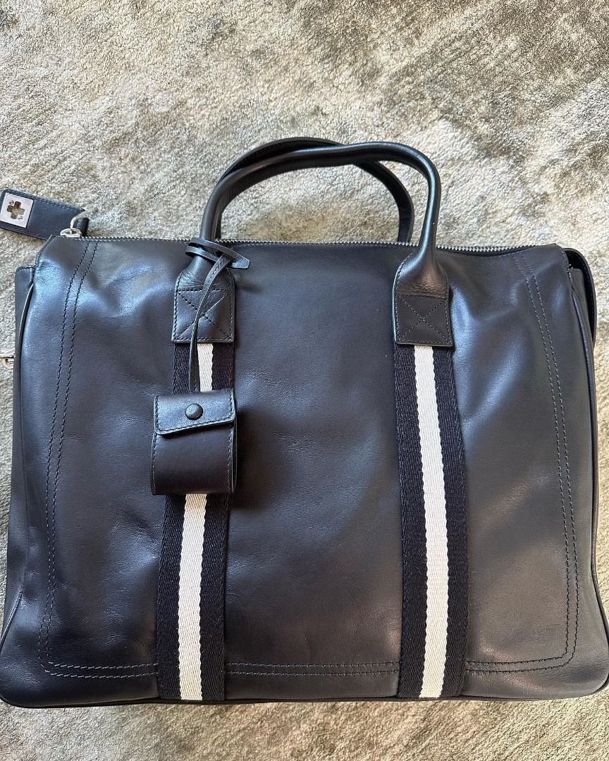 BALLY LEATHER BRIEFCASE (Category: Briefcases) located in San Isidro, Davao del Norte. Submitted by nikkody226_488 (Listing ID 1471194871, Image 2). Description: BALLY LEATHER BRIEFCASE Black Leather with Signature Black and White Webbing Details Silver Hardware Features double rolled leather handles, secure lock with two keys, fabric lining, and one deep zippered pocket. Dimensions: 40 x 34 x 10 cm Price: 3,500 Condition is like new, never used.