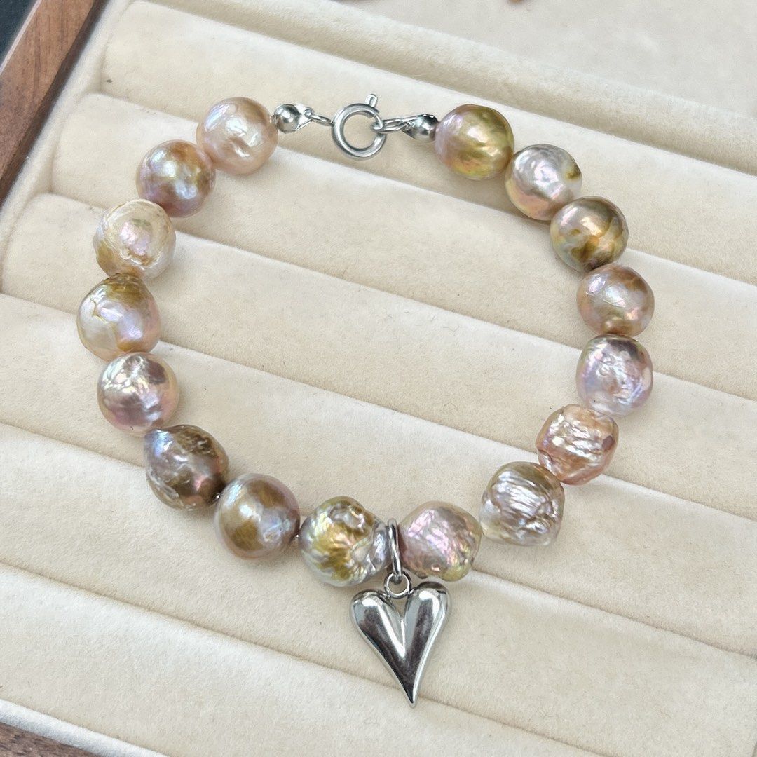 Bangle style curly pearls in metallic luster (Category: Bracelets) located in Lipa City. Submitted by avenueusco_ph (Listing ID 1471147211, Image 2). Description: Metallic luster curly pearls. ✨ With fishbites and growth color but not visible when worn. 🦪✨ 11mm pearl size Metallic luster in purple and pinkish color 8” Nonfading setting.